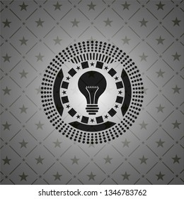 light bulb icon inside black emblem