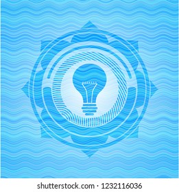 light bulb icon inside light blue water style badge.