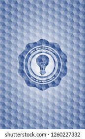 light bulb icon inside blue hexagon emblem.