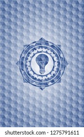 light bulb icon inside blue badge with geometric pattern.