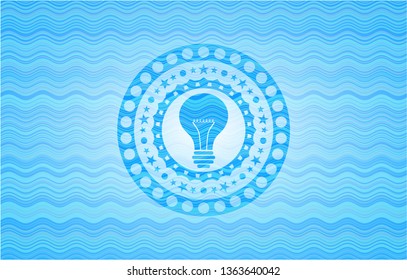 light bulb icon inside light blue water wave emblem background.