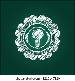 light bulb icon inside chalk emblem