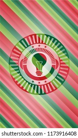 light bulb icon inside christmas colors style badge.