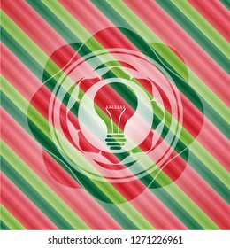 light bulb icon inside christmas colors style emblem.