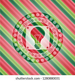 light bulb icon inside christmas badge.