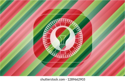 light bulb icon inside christmas colors emblem.