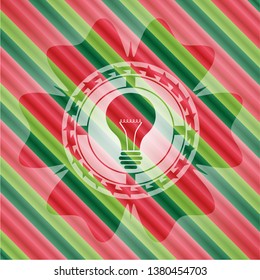 light bulb icon inside christmas colors emblem.