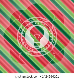 light bulb icon inside christmas style badge..