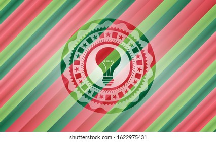 light bulb icon inside christmas colors badge.