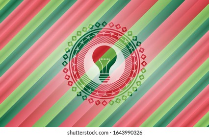 light bulb icon inside christmas style badge..