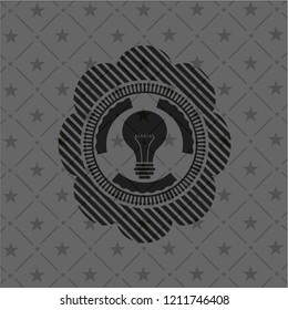 light bulb icon inside dark emblem