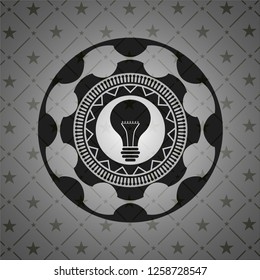 light bulb icon inside dark emblem. Retro