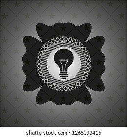light bulb icon inside dark emblem. Retro
