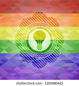 light bulb icon inside emblem on mosaic background with the colors of the LGBT flag
