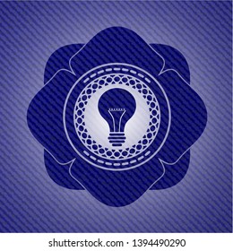 light bulb icon inside emblem with denim texture