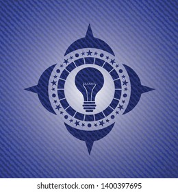 light bulb icon inside emblem with denim texture