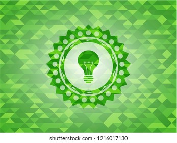light bulb icon inside green emblem with triangle mosaic background