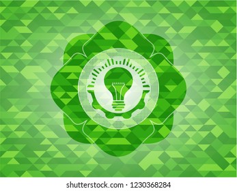 light bulb icon inside green emblem with mosaic ecological style background