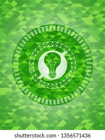 light bulb icon inside green mosaic emblem