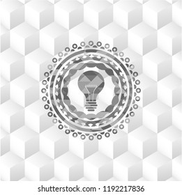 light bulb icon inside grey emblem with cube white background