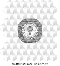 light bulb icon inside grey badge with geometric cube white background
