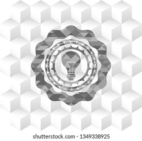 light bulb icon inside grey badge with geometric cube white background