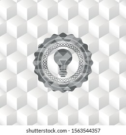 light bulb icon inside grey badge with geometric cube white background