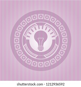 light bulb icon inside pink emblem