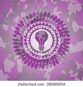 light bulb icon inside pink camo emblem. 