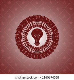 light bulb icon inside realistic red emblem