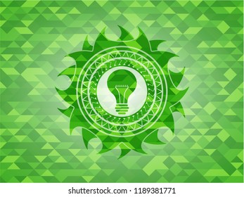 light bulb icon inside realistic green emblem. Mosaic background