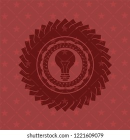 light bulb icon inside realistic red emblem