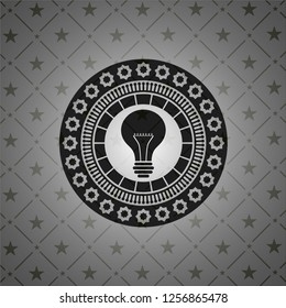 light bulb icon inside realistic dark emblem