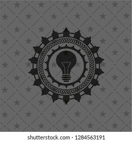 light bulb icon inside realistic black emblem