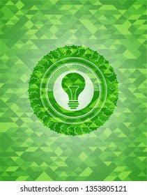 light bulb icon inside realistic green mosaic emblem