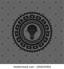 light bulb icon inside realistic black emblem