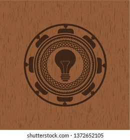 light bulb icon inside realistic wood emblem