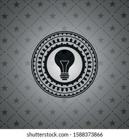 light bulb icon inside realistic dark emblem