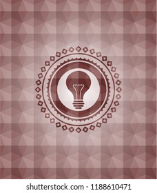light bulb icon inside red seamless emblem or badge with abstract geometric pattern background.