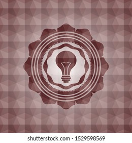 light bulb icon inside red seamless emblem with geometric pattern.