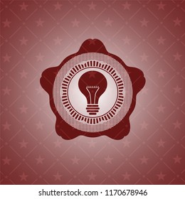 light bulb icon inside retro red emblem