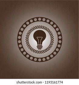 light bulb icon inside retro wood emblem