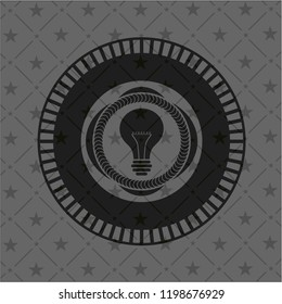 light bulb icon inside retro style black emblem