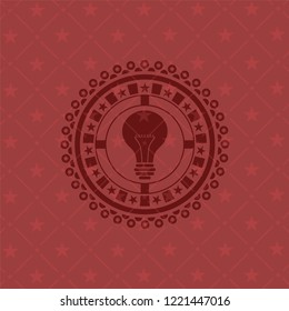 light bulb icon inside retro red emblem