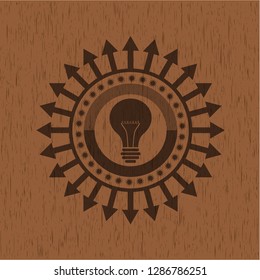 light bulb icon inside retro style wooden emblem