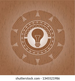 light bulb icon inside retro wooden emblem
