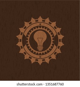 light bulb icon inside retro style wood emblem