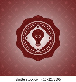 light bulb icon inside retro red emblem