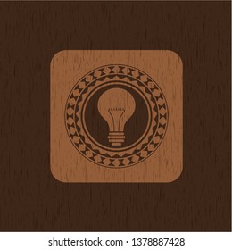 light bulb icon inside retro wood emblem
