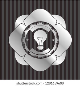 light bulb icon inside silver badge or emblem
